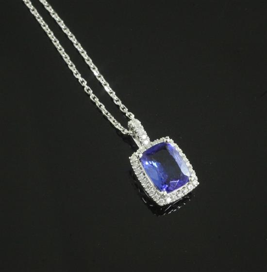 A modern 18ct white gold, tanzanite and diamond set pendant on an 18ct white gold fine link chain, pendant 16mm.